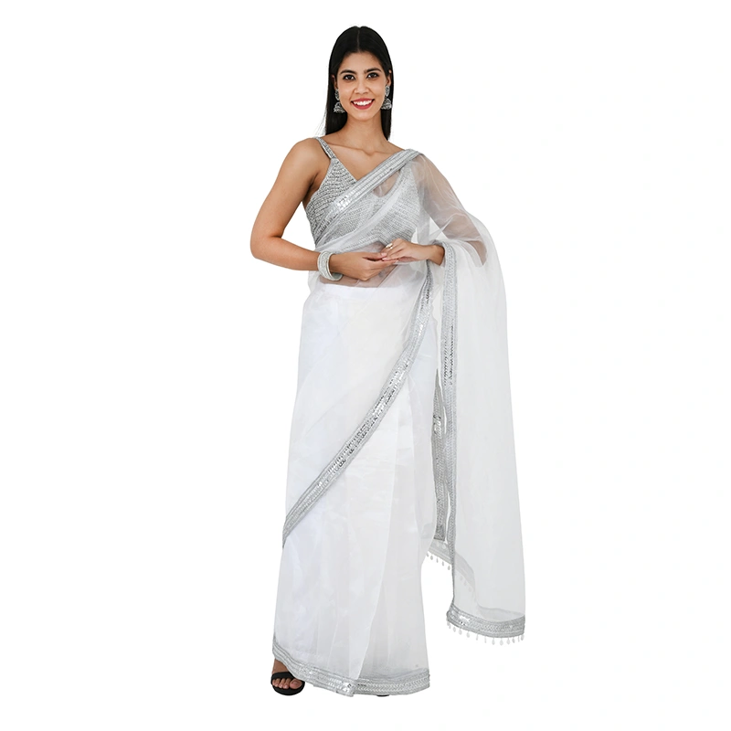 Female model in white organza saree with silver sequin border and sleeveless blouse - ethnic wear ecommerce photography by Lohar Studio Delhi